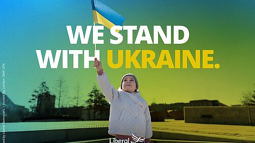 The words "We stand with Ukraine" with a young girl holding up a Ukrainian flag.