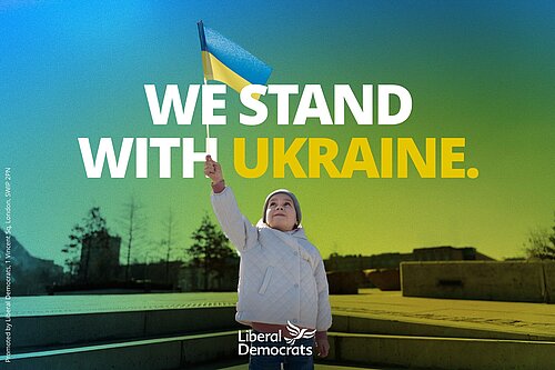 The words "We stand with Ukraine" with a young girl holding up a Ukrainian flag.