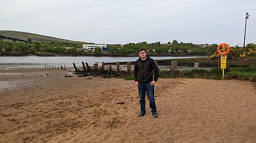 Grant Toghill standing on Erskine Beach