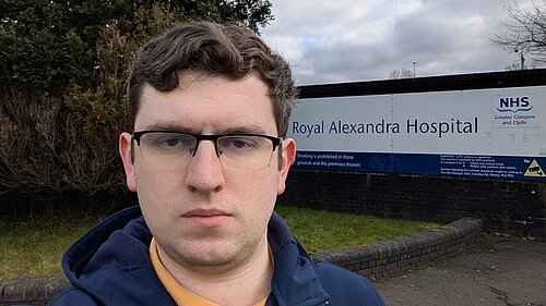 Grant Toghill with the sign for the Royal Alexandria Hospital behind.