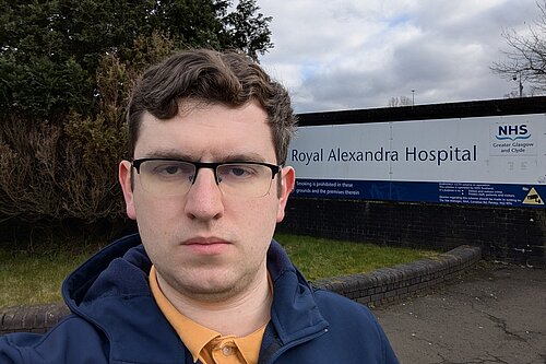 Grant Toghill with the sign for the Royal Alexandria Hospital behind.